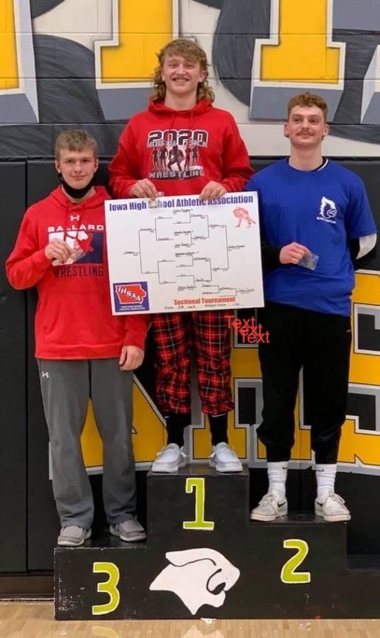Dylan Meiners holding his winning bracket on the podium next to his competitors on Feb. 7, 2021.
