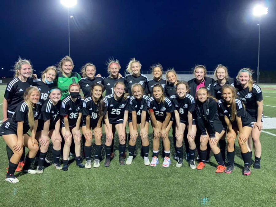 Kickin’ it- The 2021 varsity girls’ soccer team gathers after a game. So far the team has a 7-2 winning streak. 
