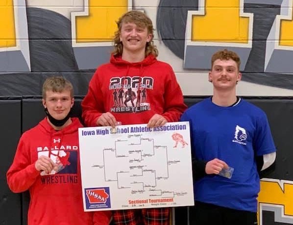 Dylan Meiners holding his winning bracket on the podium next to his competitors on Feb. 7, 2021.