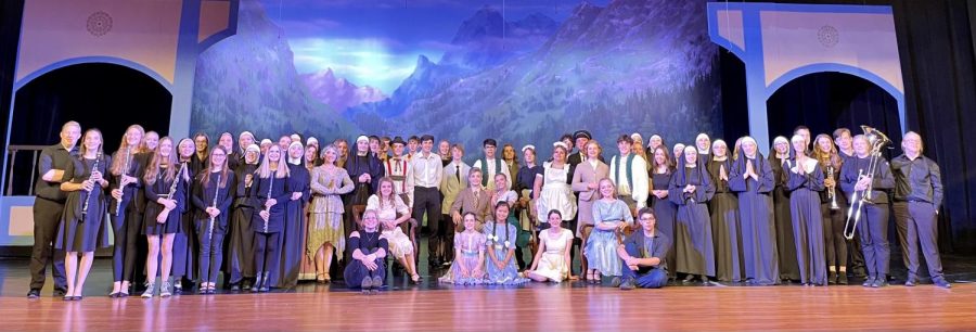 The cast of The Sound of Music gather for a group photo after a performance. 