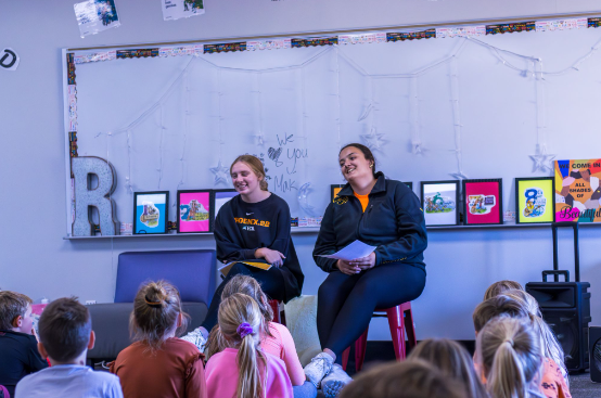 Seniors Addison Ollendike (left) and Sonia Meza (right) participated in Unity Day through interacting with students at Central Elementary. 