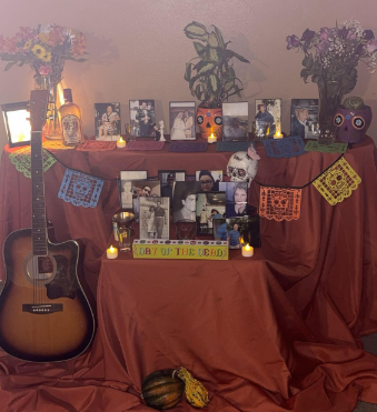 My family's altar setup; some of the biggest things we include are water, candles and incense, flowers, favorite drinks and food and objects enjoyed during their lives. 